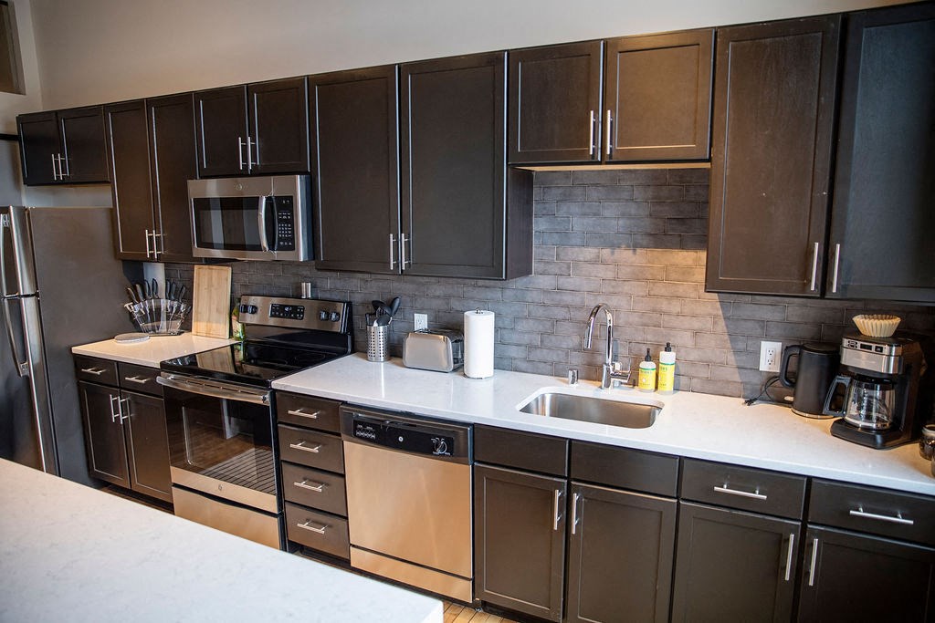 a kitchen with stainless steel appliances and a counter top