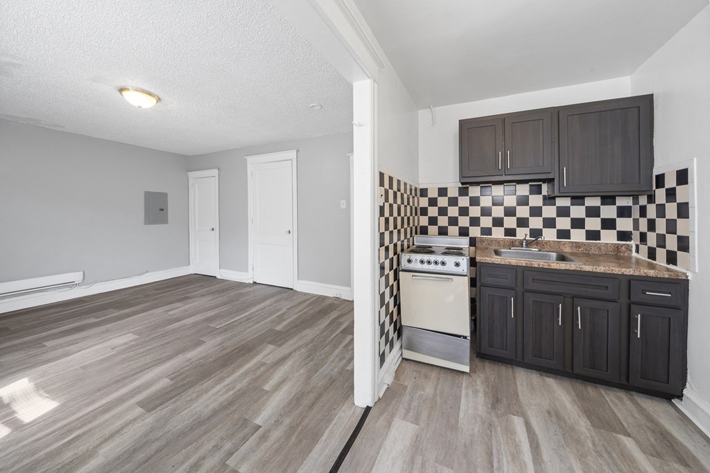 the kitchen and living room of a renovated apartment