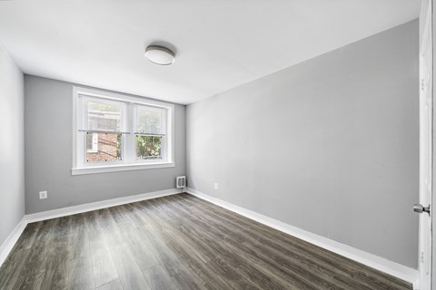 A room with a window and a door.