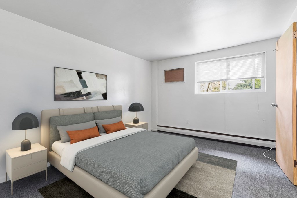 a bedroom with a bed and a window