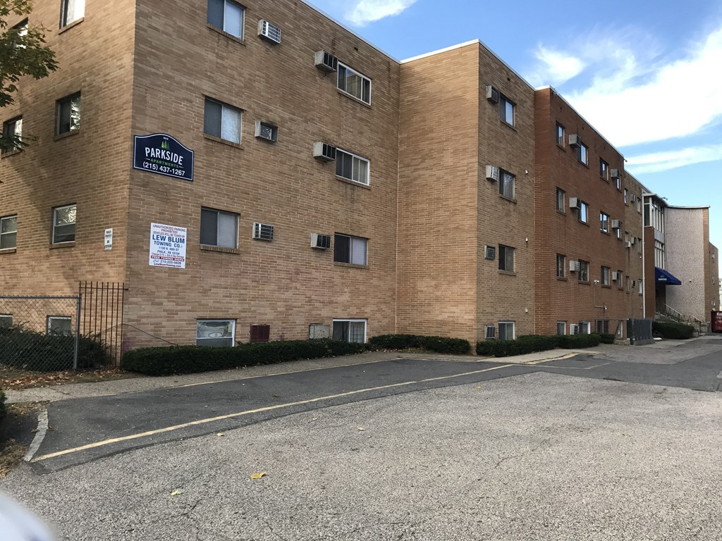 a large brick building with a street in front of it