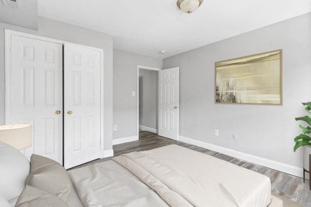 a white bedroom with a white couch and a white door