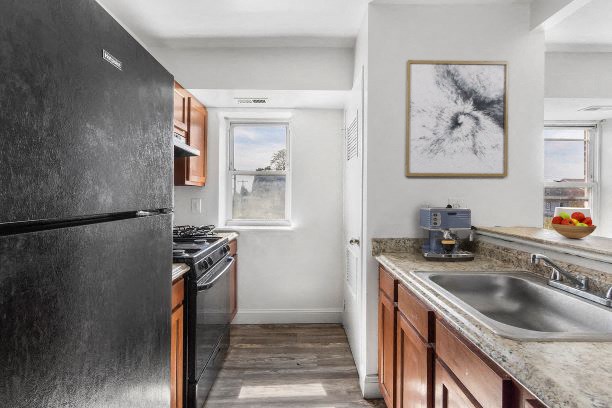 a kitchen with a sink and a refrigerator