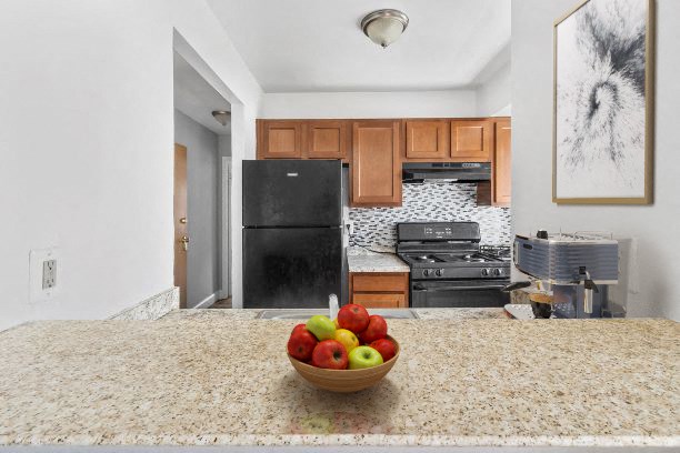 a kitchen with a bowl of fruit on the counter