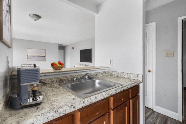 a kitchen with a sink and a coffee maker