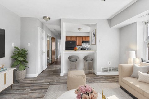 a living room and kitchen with a couch and a table