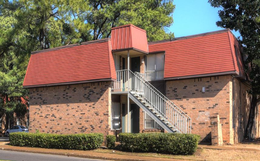 a red brick building with a balcony on the side
