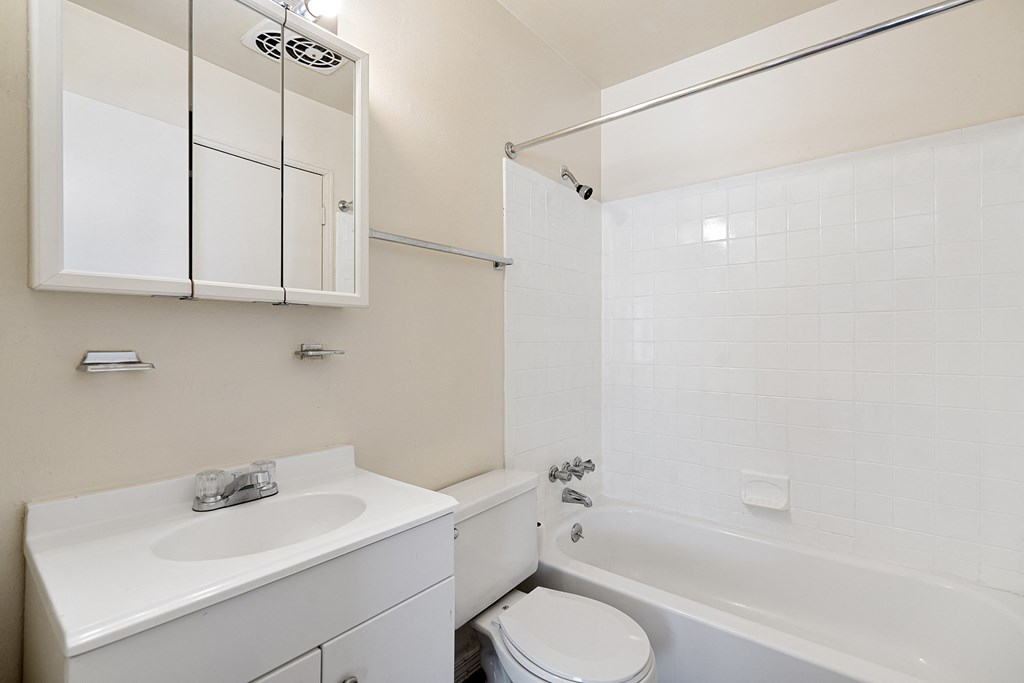 a bathroom with a sink toilet and bath tub