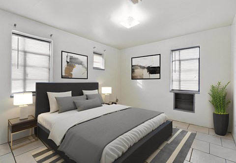 a bedroom with a bed and two windows