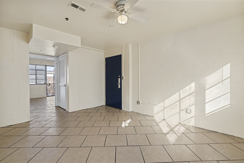 the living room of a house with a ceiling fan