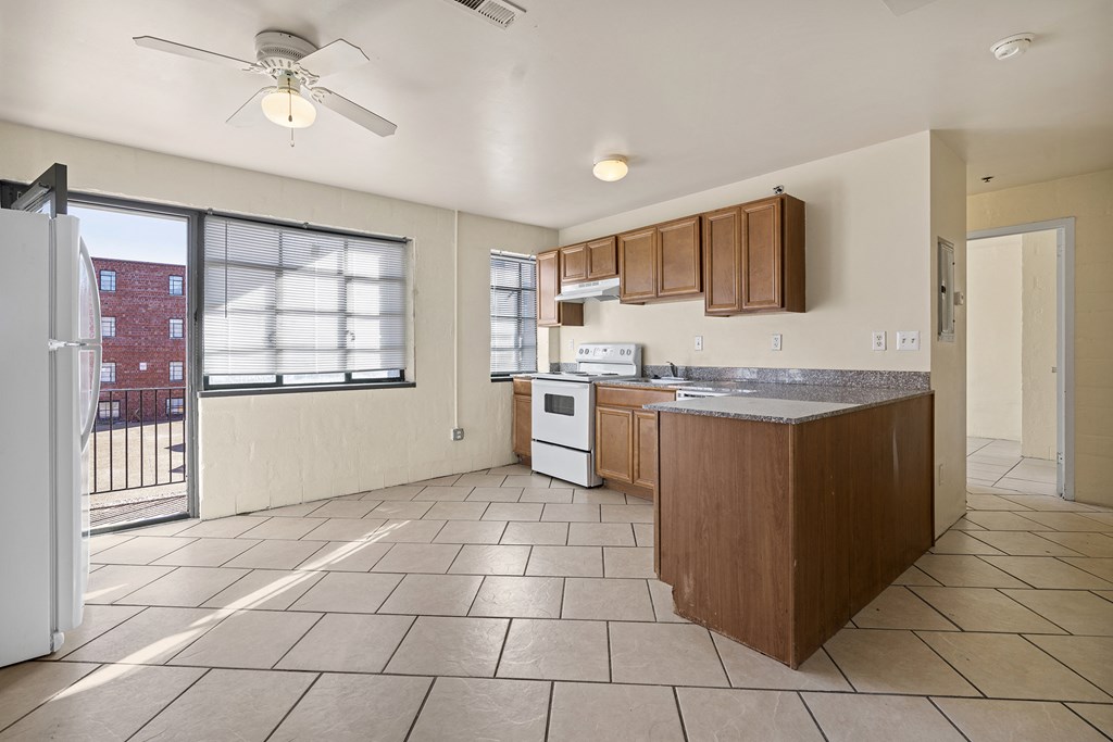 an empty kitchen with a door to a balcony