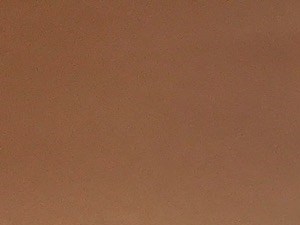 an empty living room with wood floors and a window