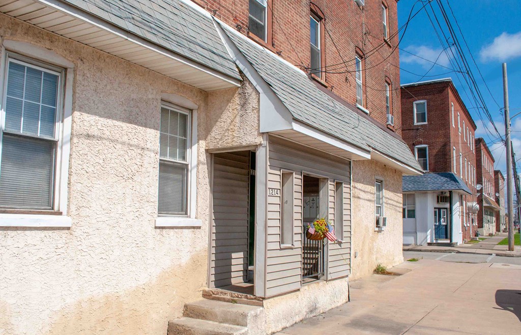 a small white building with a porch and a window