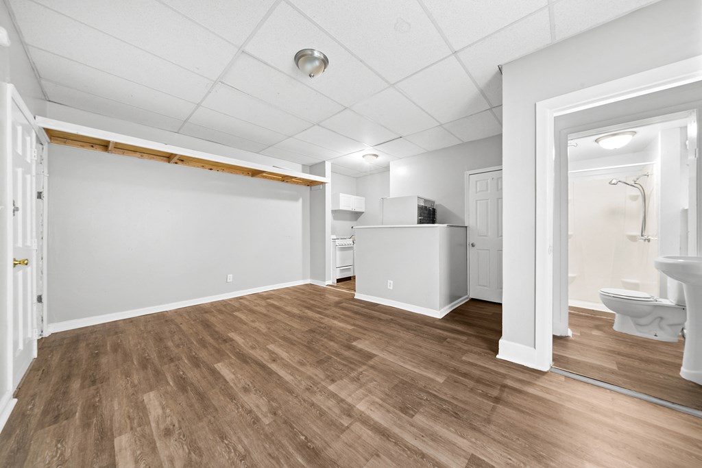 the living room and dining room of a renovated house with wood flooring