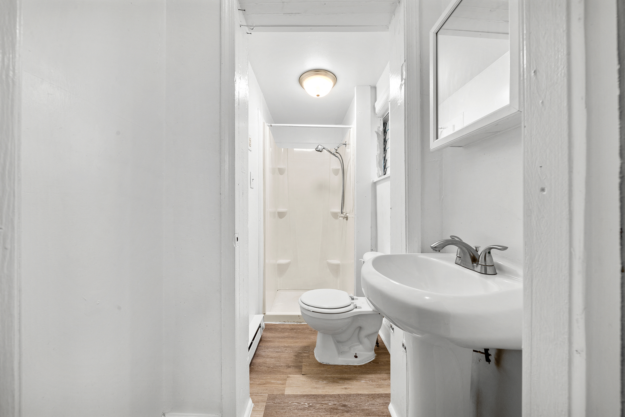 a bathroom with a sink and a toilet and a shower