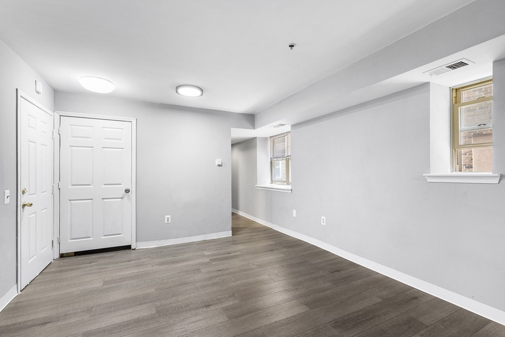 an empty room with white walls and a white door