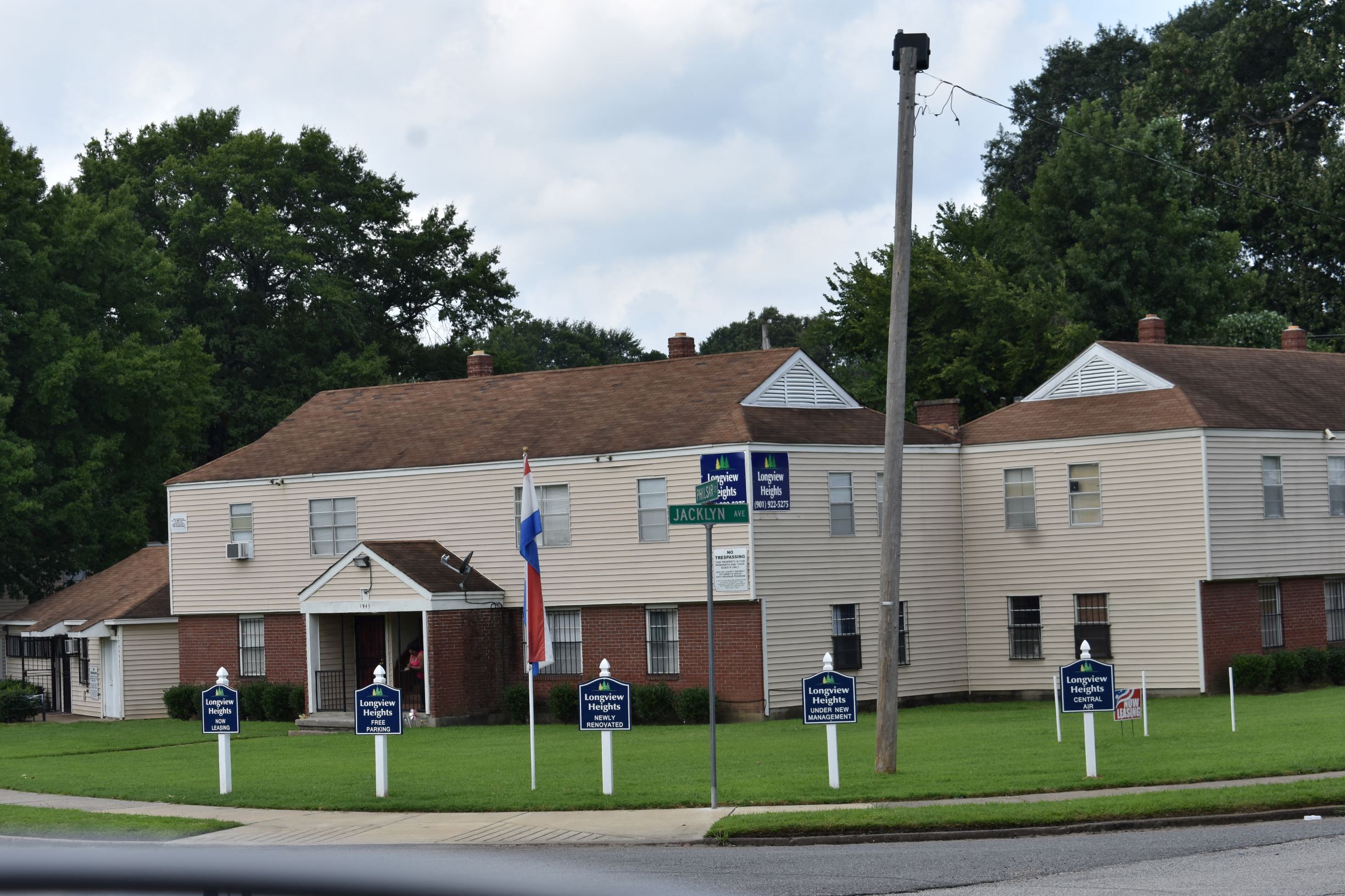 a large white house with signs in front of it