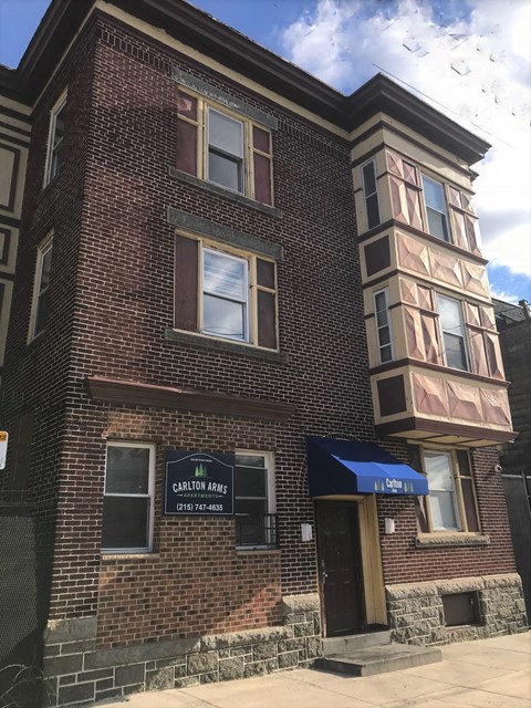 a red brick building with a blue awning