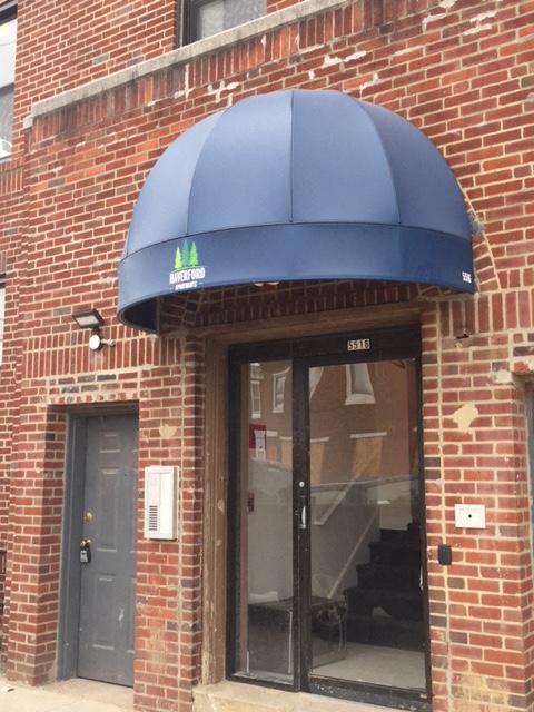 A blue awning with a logo on it.