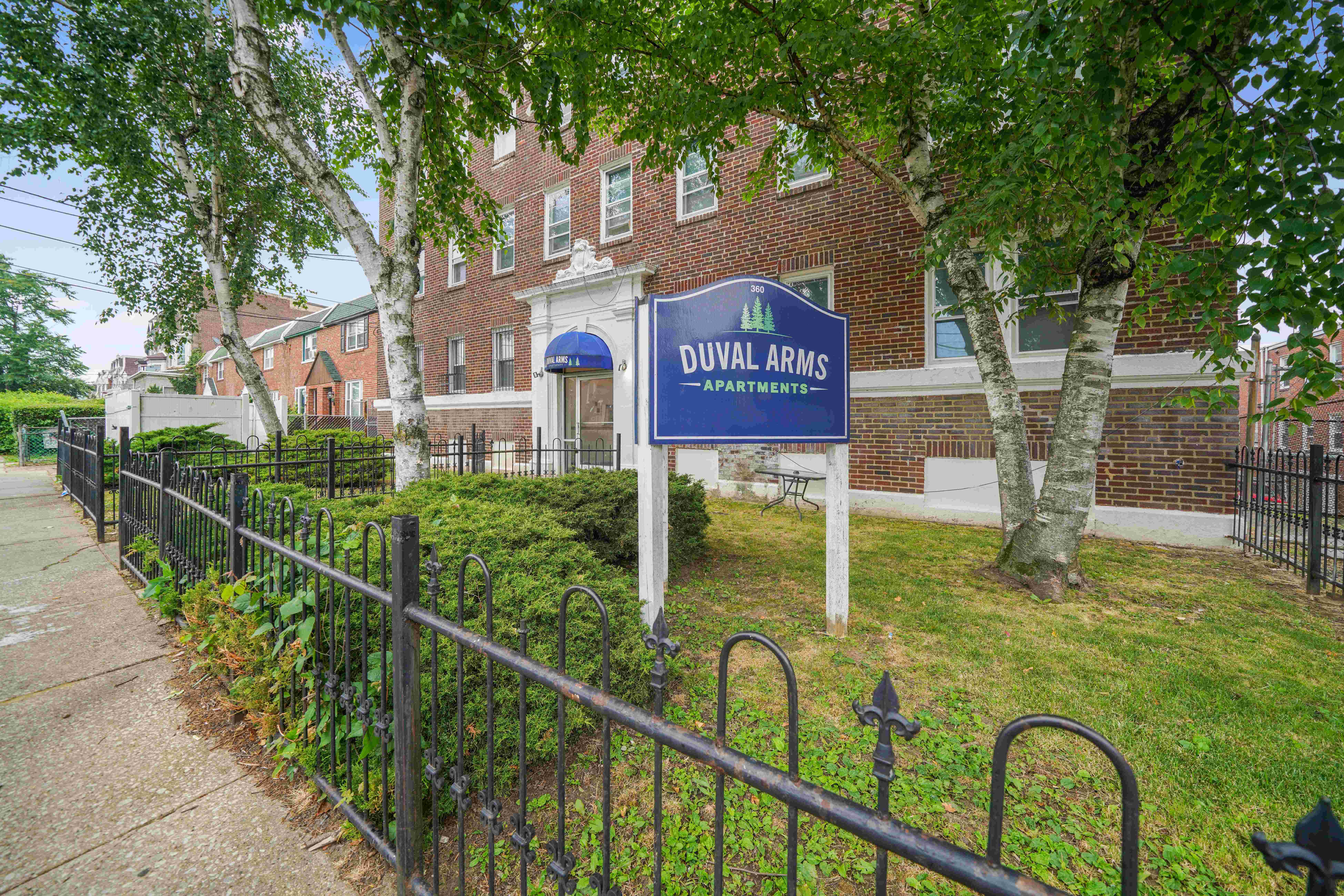 a blue and white sign in front of a brick building