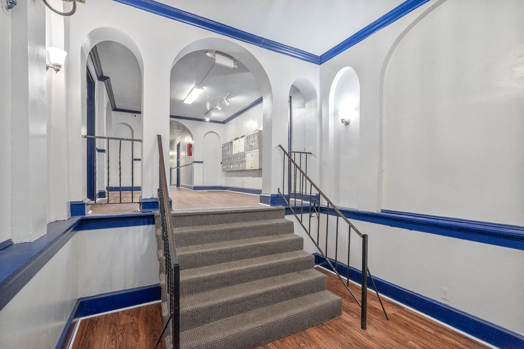 A staircase with a blue stripe on the wall.
