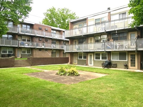 a grassy courtyard in the middle of an apartment building