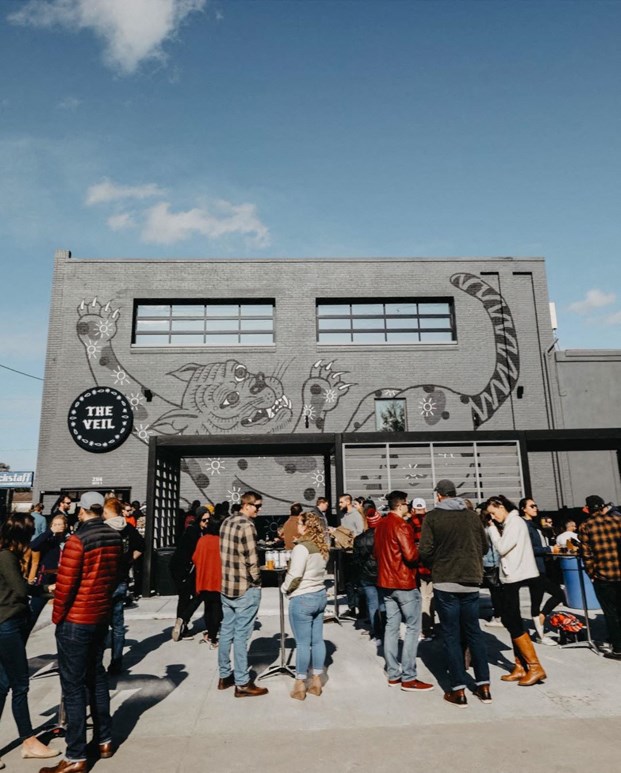 a crowd of people standing in front of a building