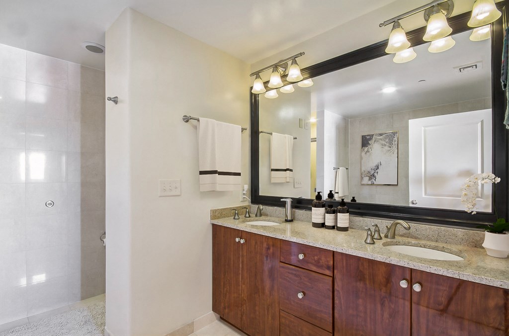 a bathroom with two sinks and a large mirror