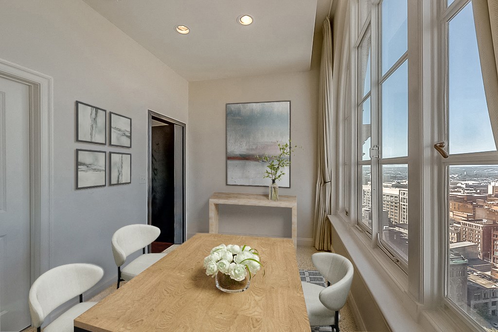a dining room with large windows and a wooden table