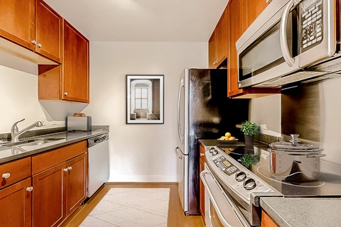 a kitchen with stainless steel appliances and wooden cabinets