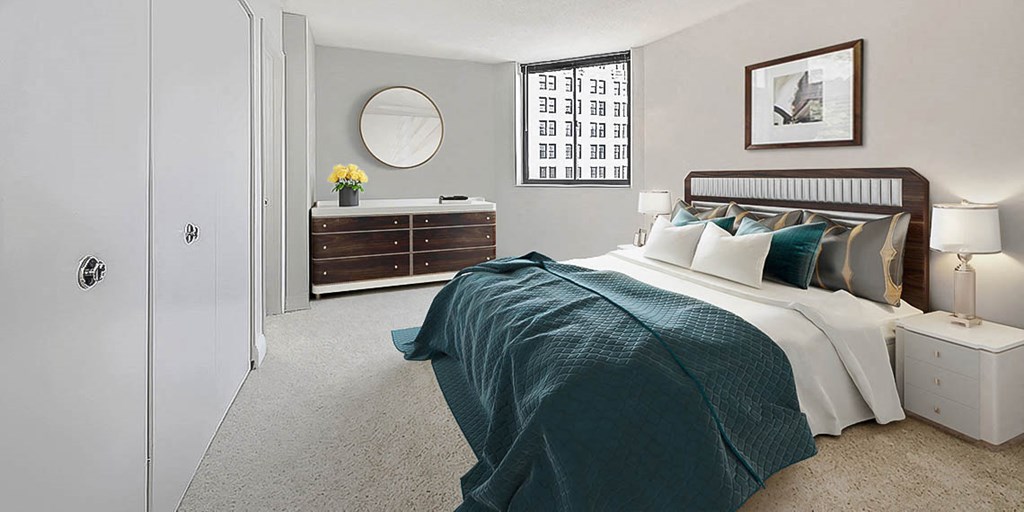 a bedroom with a bed and a dresser