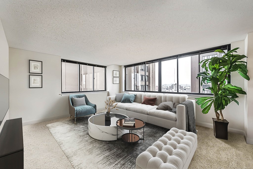 a living room with a white couch and a large window