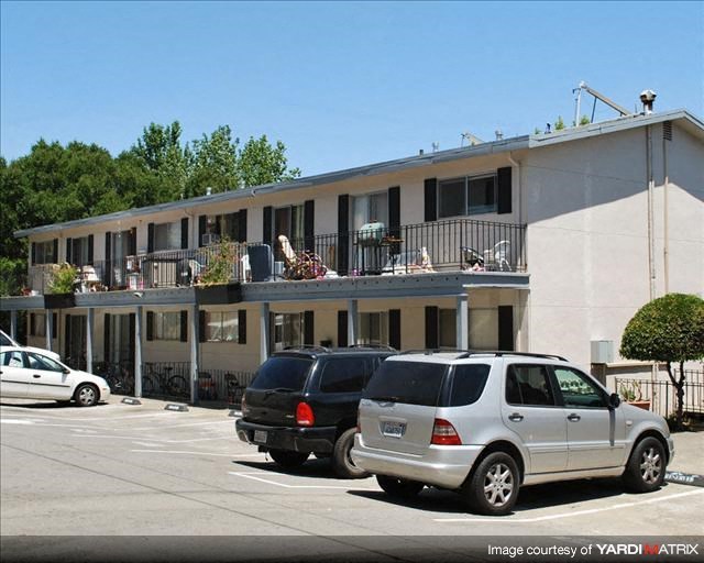a building with cars parked in a parking lot