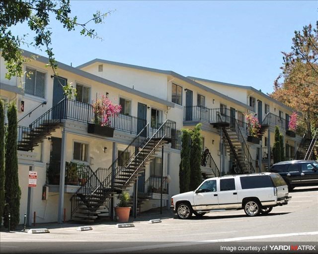 a white van parked in front of an apartment building