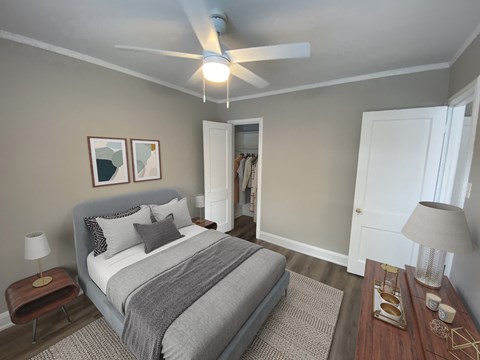 a bedroom with a bed and a ceiling fan