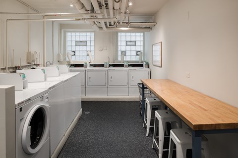 A laundry room with washers and dryers.