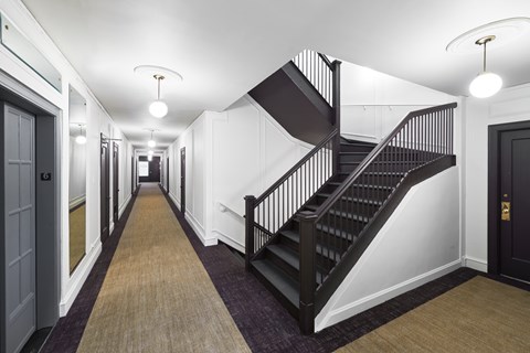 A long hallway with a staircase on the right side.
