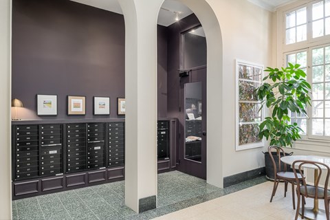 a dining room with a table and chairs and a large cabinet with drawers