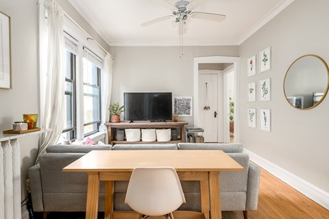a living room with a couch and a table and a tv