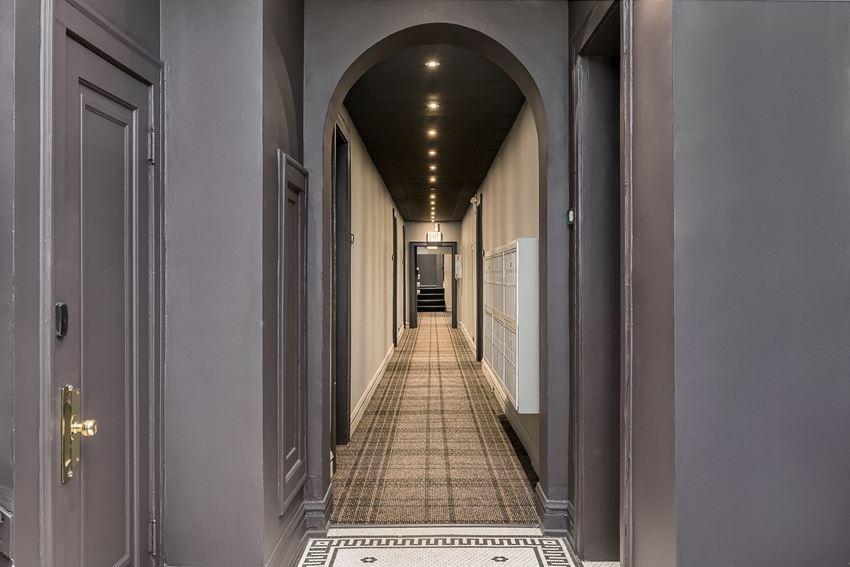 a hallway with an archway and a tiled floor