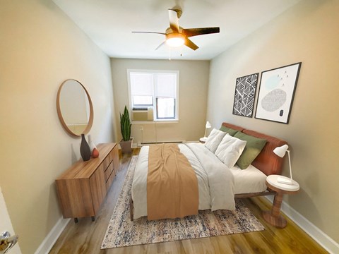 a bedroom with a bed and a ceiling fan
