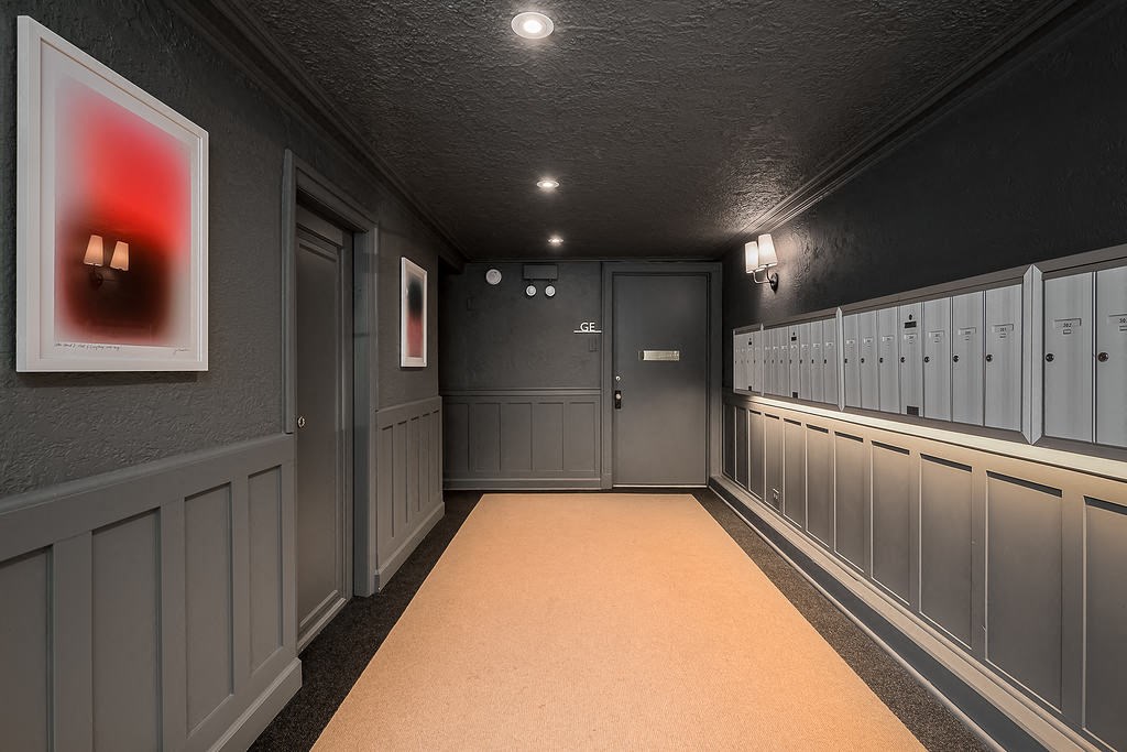 a gray locker room with gray cabinets and a yellow carpet