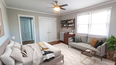 A living room with a couch, a coffee table, and a ceiling fan.