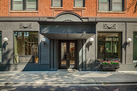 A building with a grey facade and a black awning.