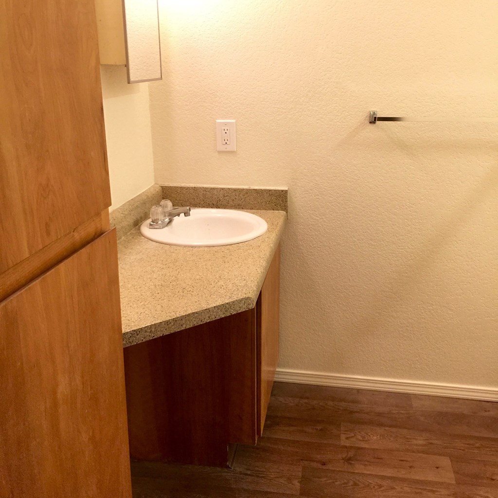 a bathroom with a sink and a wooden door