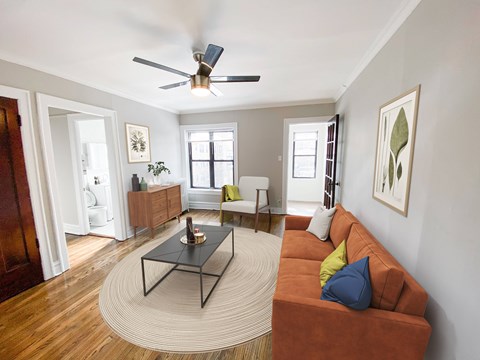 A living room with a brown couch and a black coffee table.