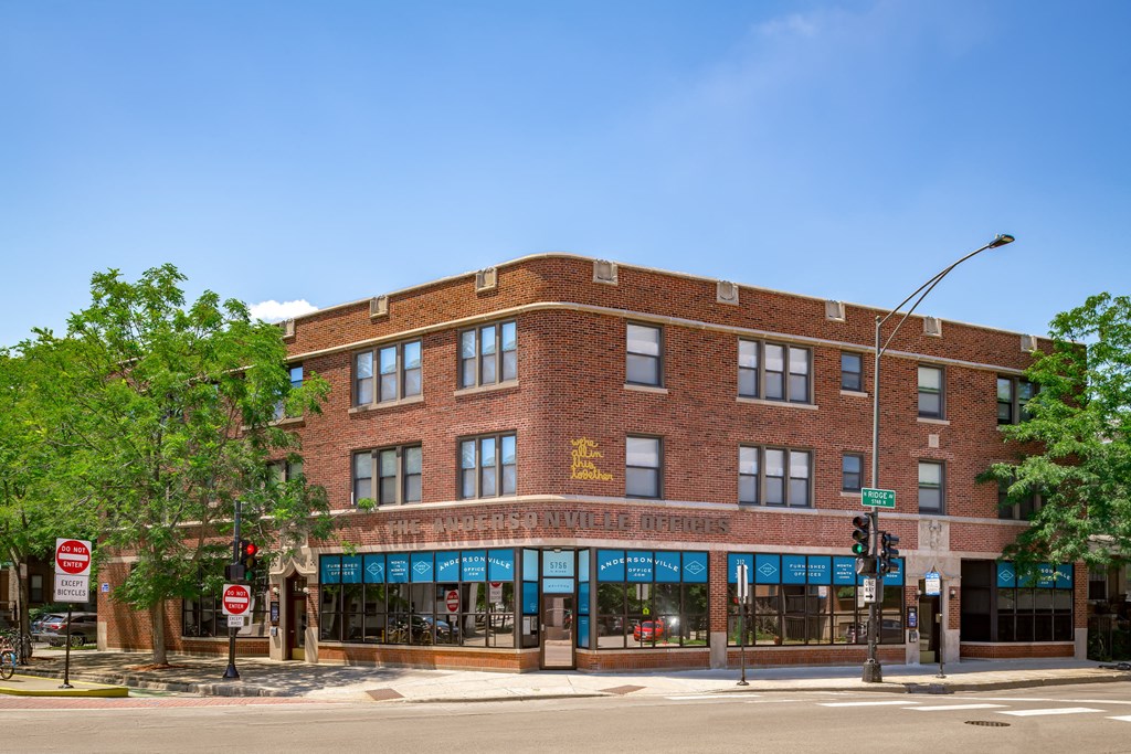 a red brick building on the corner of a street