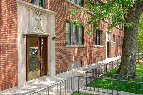 a brick building with a tree in front of it