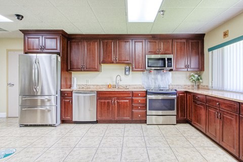 a large kitchen with wooden cabinets and stainless steel appliances