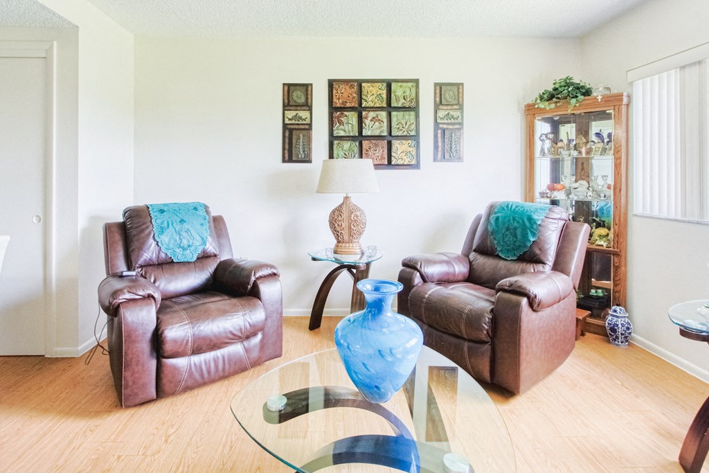 comfortable recliners in living room with hardwood-style flooring